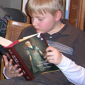 image of young boy reading a book